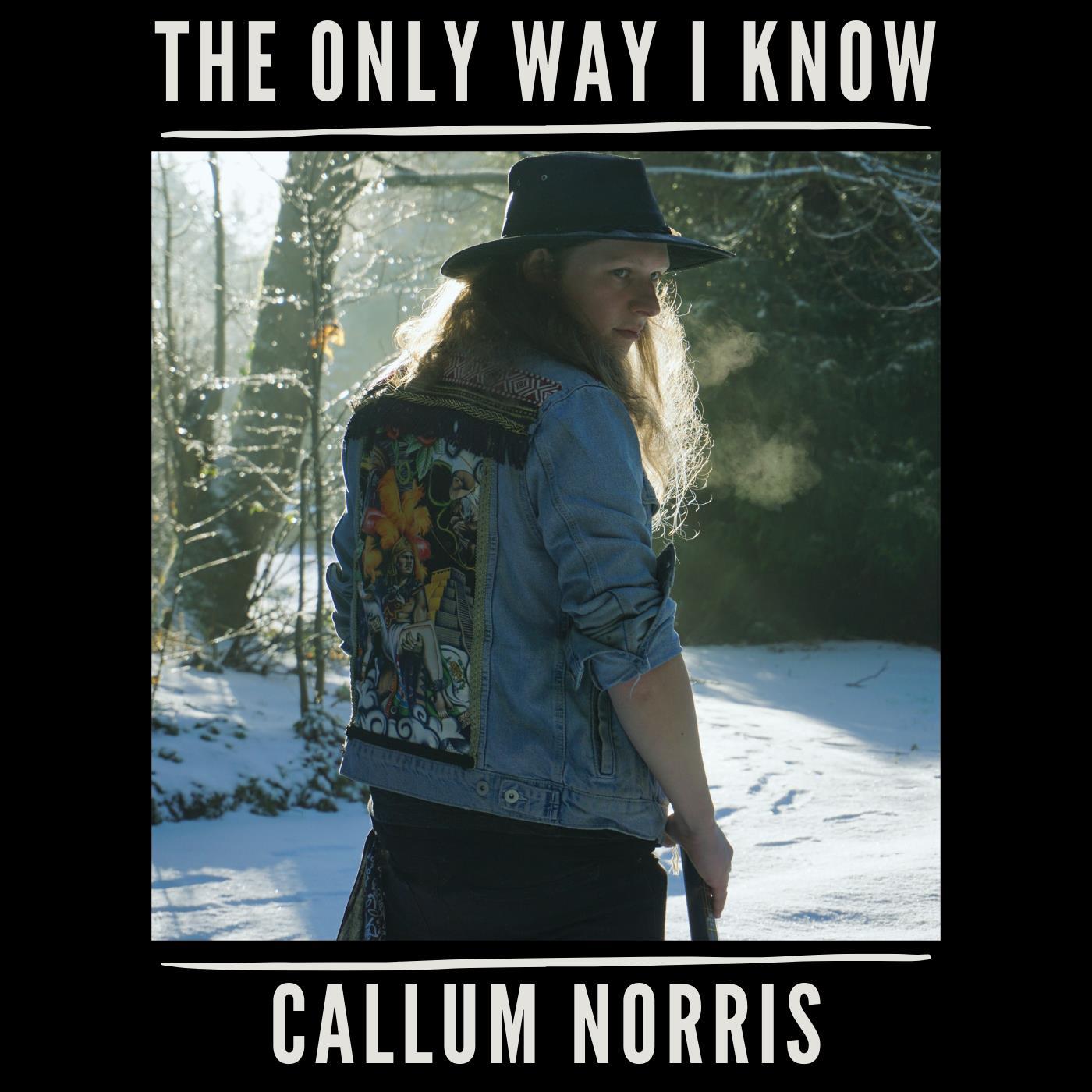 Northern Irish rock and blues artist standing in a forest in the snow with latest single title "The Only Way I Know" printed on a back background